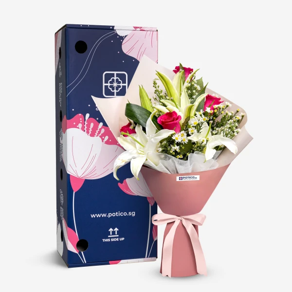 Pink roses and white lilies bouquet wrapped in pink paper with a pink ribbon bow.