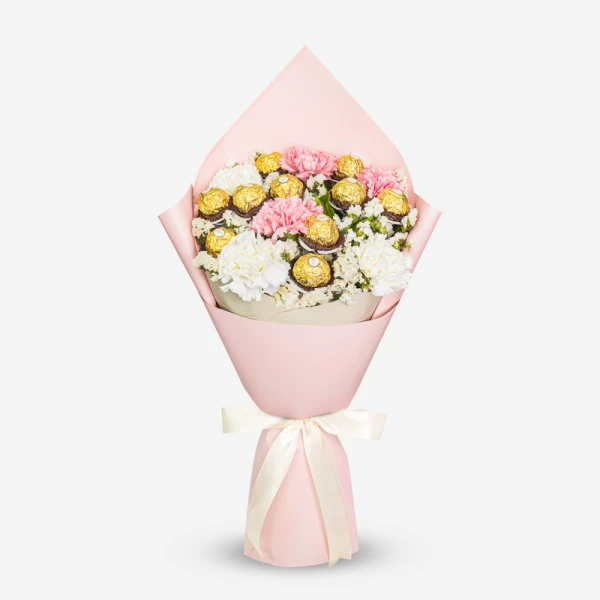 Pink bouquet of carnations and Ferrero Rocher chocolates with a cream ribbon.