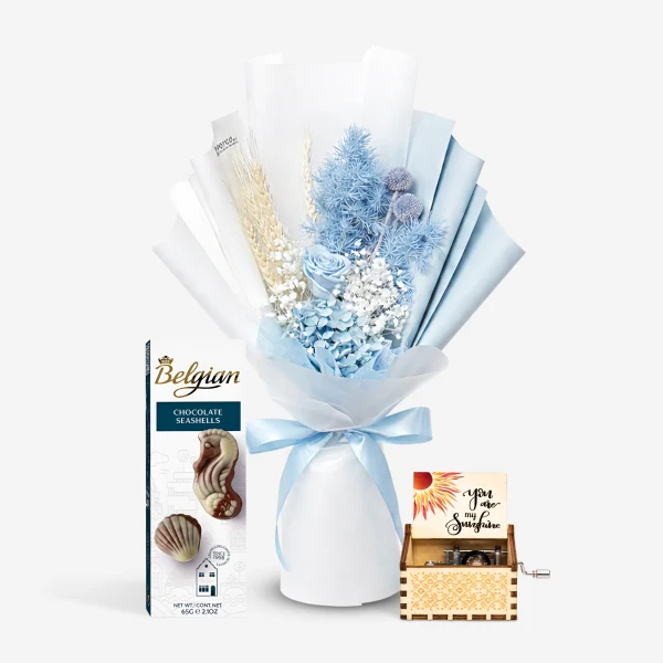 Blue preserved flower bouquet with Belgian chocolate seashells and a wooden music box.