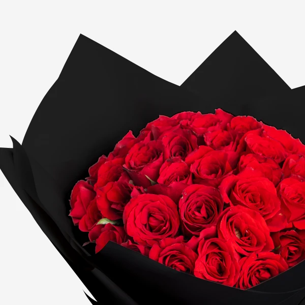 A large bouquet of 50 red roses wrapped in black paper.