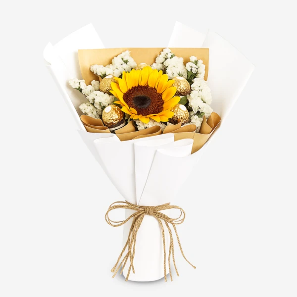 Sunflower and Ferrero Rocher bouquet wrapped in white paper, tied with twine.