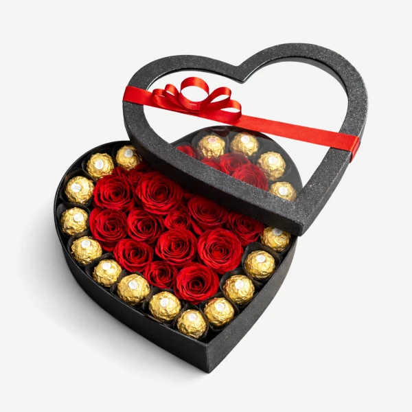 Heart-shaped box of red roses and gold-wrapped chocolates, tied with a red ribbon.