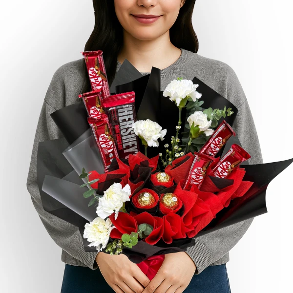 Chocolate and flower bouquet with KitKats, Hershey's, Ferrero Rocher, and white carnations.