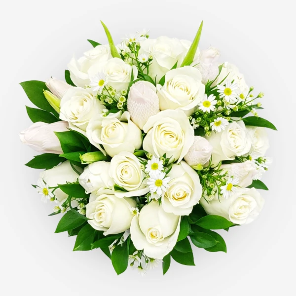 A round bouquet of white roses, tulips, and daisies with green leaves.
