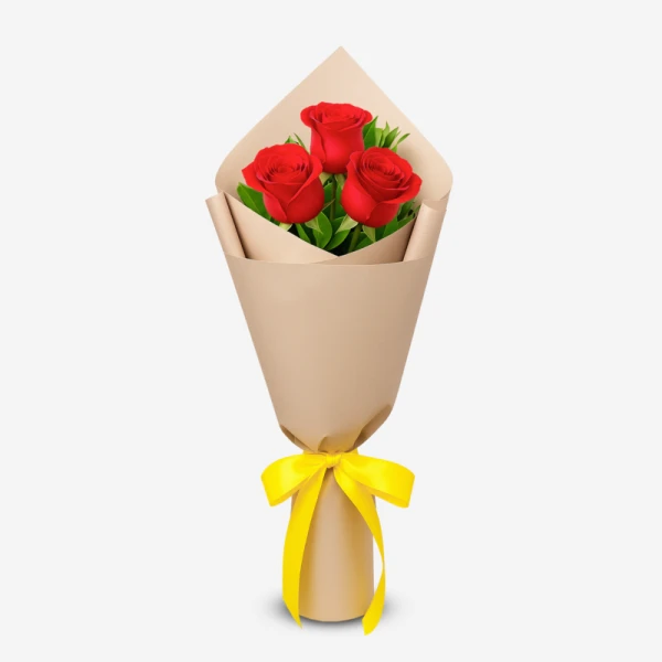 Three red roses elegantly wrapped in brown paper, tied with a yellow ribbon.