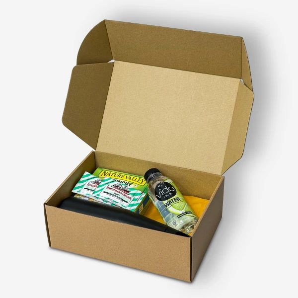 Open gift box with football plushie, tumbler, Nature Valley bars, and lime water.