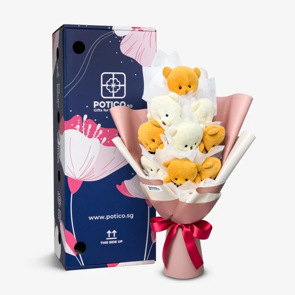 A bouquet of small teddy bears in a pink wrapper with a pink ribbon, next to a blue box.