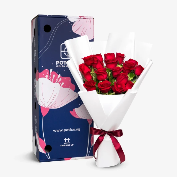 A box of 18 red roses with a white wrapping and red ribbon, next to a blue box with floral designs.