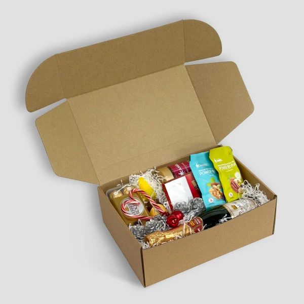 Gift box filled with chocolates, snacks, a bottle of sparkling juice, and festive candies.