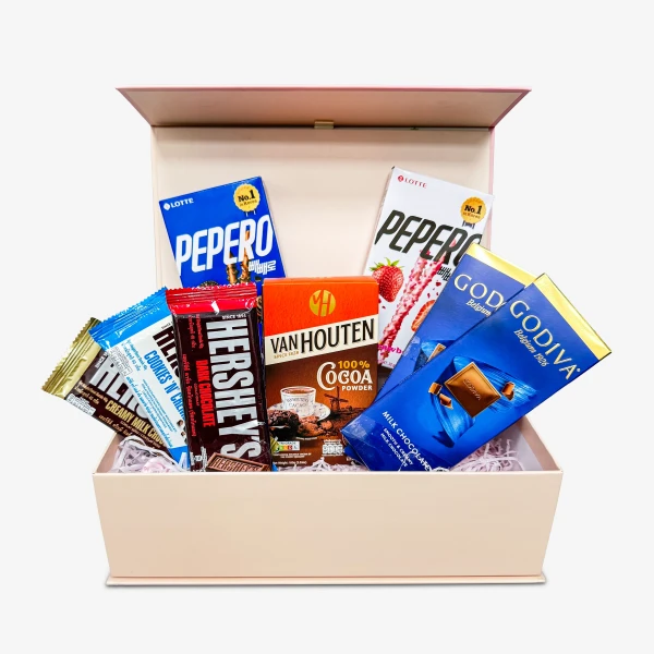 Gift box filled with Hershey's, Pepero, Van Houten cocoa, and Godiva chocolates.