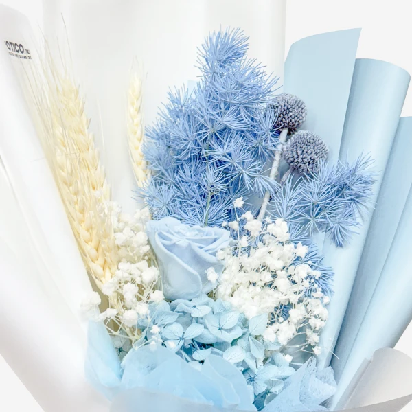 A bouquet of dried light blue flowers, white baby's breath, and wheat stalks.