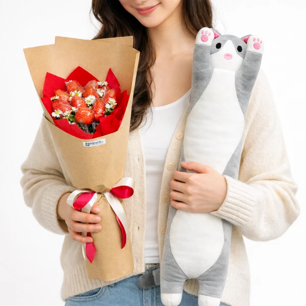 Woman holding a strawberry bouquet and a long stuffed cat toy.
