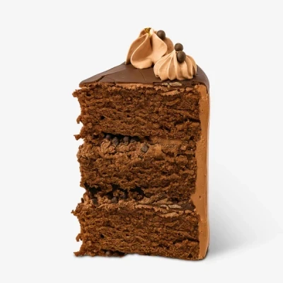 Slice of chocolate crunch cake with chocolate frosting and whipped cream topping.