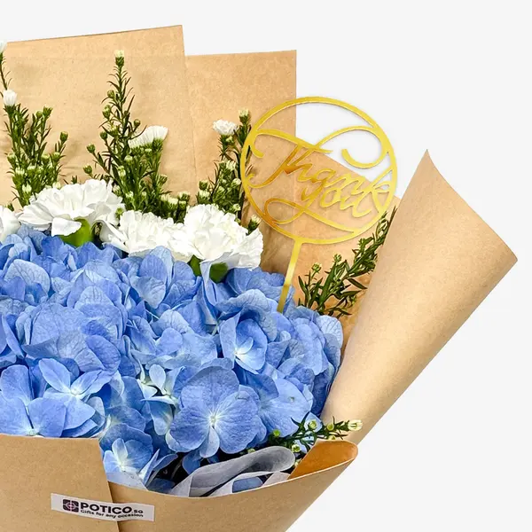 Bouquet of blue hydrangeas, white carnations, asters, and "Thank You" topper.