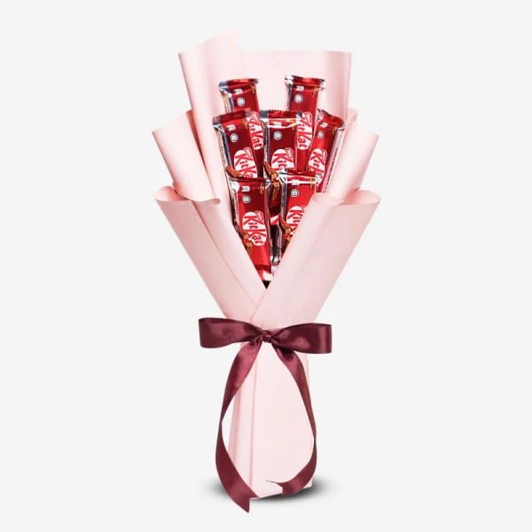 KitKat bouquet with 7 milk chocolate bars, wrapped in pink paper and tied with a burgundy ribbon.