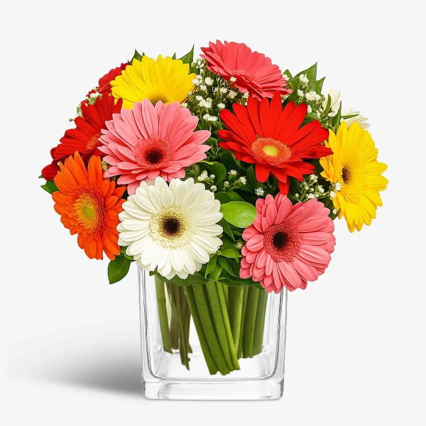 A glass vase holds a vibrant bouquet of gerbera daisies in pink, red, orange, yellow, and white.
