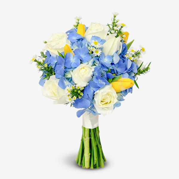 Bouquet of white roses, blue hydrangeas, yellow tulips, and daisies tied with a white ribbon.