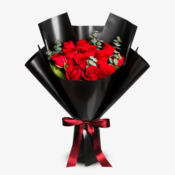 Bouquet of 12 red roses wrapped in black paper with a red ribbon.