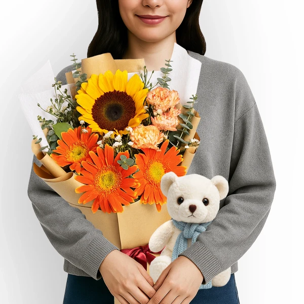 Woman holding a bouquet of sunflowers and orange gerbera daisies with a teddy bear.