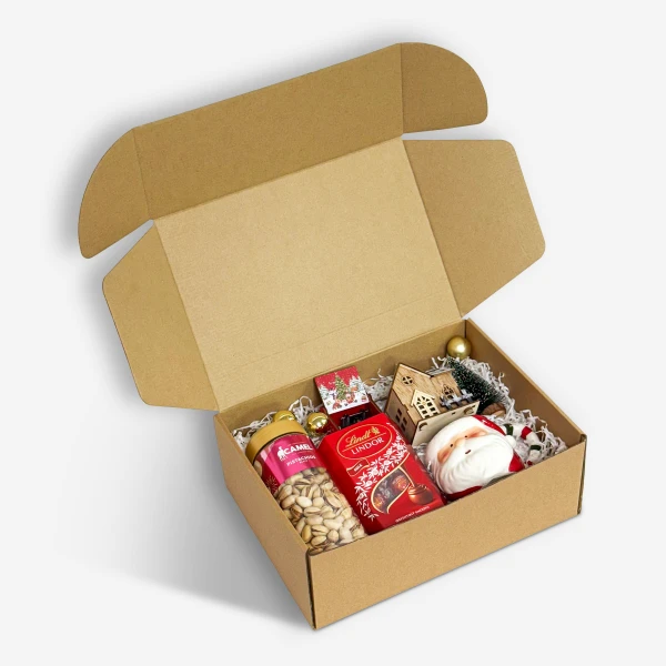 Christmas gift box with pistachios, chocolates, a Santa figure, and miniature house.