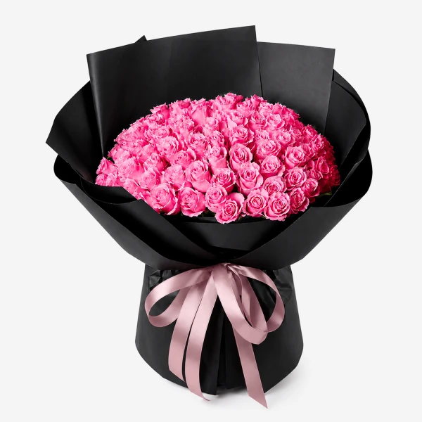 Bouquet of 100 pink roses in black paper with a pink ribbon.