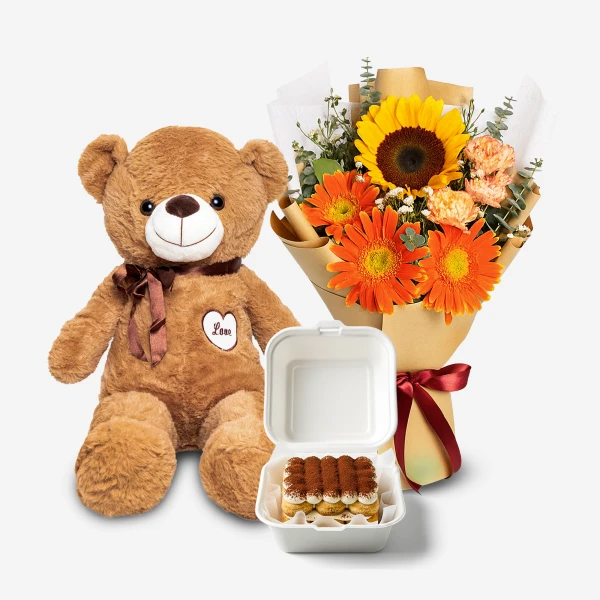A teddy bear, a bouquet of sunflowers and gerberas, and a tiramisu bento.