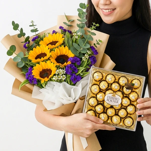 Woman holding a bouquet of sunflowers and a box of Ferrero Rocher chocolates.