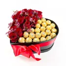 Heart-shaped box with red roses and Ferrero Rocher chocolates, tied with a red ribbon.