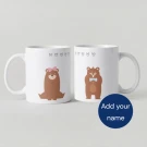 Two white mugs, one with "PEEM" in blue, the other with "PLOY" in pink.