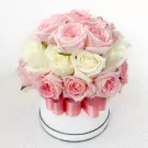 Round white box filled with 40 pink and white roses, tied with a pink ribbon.
