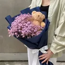 Teddy bear bouquet with pink limonium in navy blue wrap with white ribbon.
