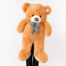 Giant, tan teddy bear with a black and white checkered bow tie.