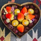 Heart-shaped box filled with strawberries, cherries, and Ferrero Rocher chocolates.