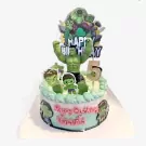 Hulk cake with "Happy Birthday" and the number 5 candle, featuring Hulk figurines and comic-style decorations.