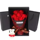 Red roses in a black box with a teddy bear and "Just For You" ribbon.