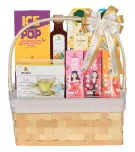 Gift basket with Doi Kham beverages, tea, and snacks, featuring bright packaging and a festive bow.