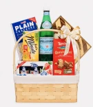 Gift basket with San Pellegrino, crackers, tea, cookies, and jams, tied with a bow.