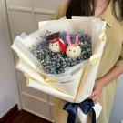 Graduation bouquet with fluffy bunny charms and baby's breath flowers.