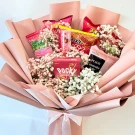 Pink-wrapped bouquet filled with Pocky, chips, and baby's breath.
