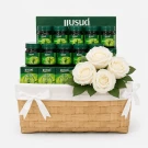 Gift basket filled with Brand's Essence of Chicken bottles and white flowers.