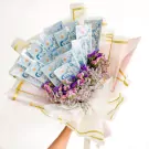 A money bouquet with 50-unit banknotes and dried purple and pink flowers.