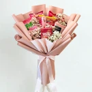 Pink snack bouquet with Pocky, Japanese chips, and baby's breath flowers.