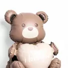 A teddy bear balloon with a heart that says "i love you!"