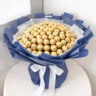 Bouquet of 100 gold-wrapped Ferrero Rocher chocolates in dark blue and white paper, tied with white ribbon.