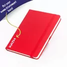 Red A5 leather journal with "KATH" embossed and elastic band.
