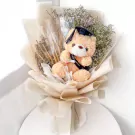 Graduation teddy bear bouquet with diploma and cap, wrapped in neutral paper.