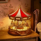 A DIY classic carousel 3D wooden puzzle on a wooden surface, illuminated by warm light.