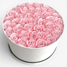 Round white box filled with 40 pink artificial roses, each with a diamond in the center.