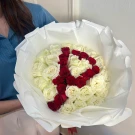 A bouquet of white and red roses arranged in the shape of the letter 'P'.