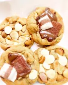Four soft baked cookies, two with Nutella and Kinder Bueno, two with white chocolate chips and macadamia nuts.